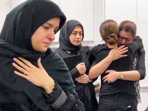 Mourners attend a vigil at University of Toronto student housing for the victims of a Ukrainian passenger jet which crashed in Iran, in a still image from video in Toronto, Ontario, Canada January 8, 2020.  