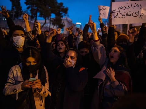 Demonstrators chant while gathering during a vigil for the victims of the Ukraine International Airlines flight that was unintentionally shot down by Iran, in Tehran, Iran, on Saturday, Jan. 11, 2019.