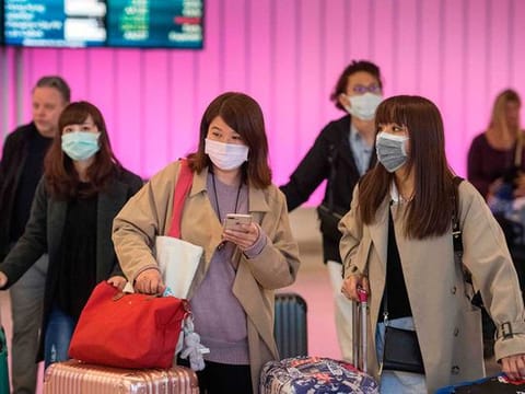 Passengers wear protective masks to protect against the spread of the Coronavirus 