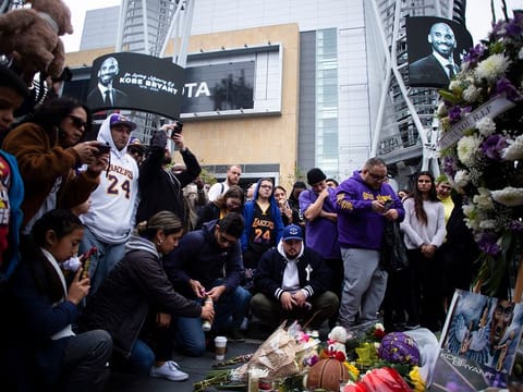 Mourners gather at a makeshift memorial for Kobe Bryant, the retired Los Angeles Lakers star, outside of the Staples Center in Los Angeles, Jan. 26, 2020.