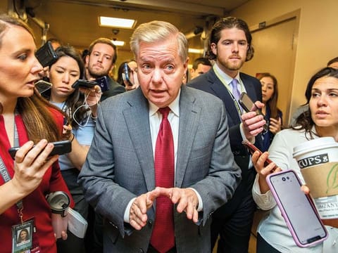Republican Sen. Lindsey Graham speaks to reporters in Washington on Monday, during the impeachment trial of  Trump on charges of abuse of power and obstruction of Congress.