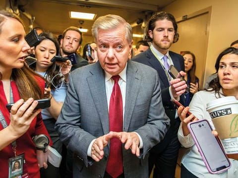 Republican Sen. Lindsey Graham speaks to reporters in Washington on Monday, during the impeachment trial of  Trump on charges of abuse of power and obstruction of Congress.