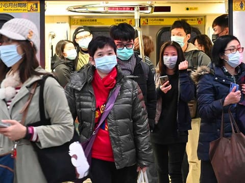 Scientists discovered the genetic mutation of the SARS-CoV-2 as early as February and it has circulated in Europe and the Americas, the World Health Organization said. The WHO has also said there is no evidence the mutation has led to more severe disease. Photo shows mask-clad commuters get off a train at a Mass Rapid Transit (MRT) stop in Taipei following the Lunar New Year holidays on January 30, 2020