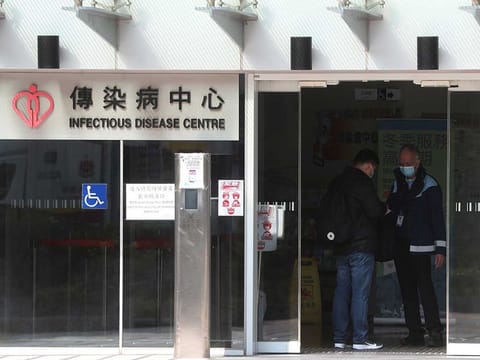 Security check a man inside the infectious disease centre at the Princess Margaret Hospital in Hong Kong.