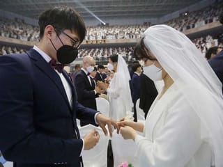 In sickness and in health: mass wedding defies coronavirus fears  