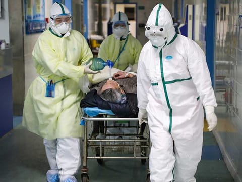 Medical workers in protective suits move a patient to an isolation ward. Picture for illustrative purposes only.