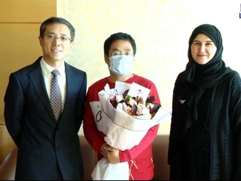 One of the newly recovered coronavirus patients, centre, with Consul-General of China to the UAE, Li Xuhang and Dr. Fatima Al Attar, Head of International Health Regulations at the Ministry.