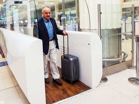 A passenger using Smart Tunnel that enable passengers to finish passport control procedures within seconds by simply walking through this biometric recognition system at Dubai International airport terminal-3.