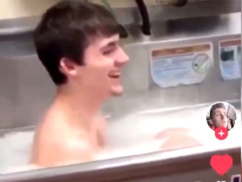 In the video, a young male is seen getting in the restaurant's oversized kitchen sink and another man wearing a Wendy's uniform is seen throwing something into the sink and saying: "Wash yourself!"