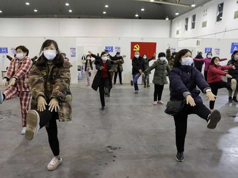 Patients dance inside the Wuhan Parlor Convention Center that has been converted into a makeshift hospital following an outbreak of the novel coronavirus, in Wuhan, Hubei province, China February 15, 2020. Picture taken February 15, 2020. 