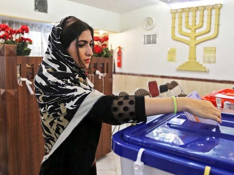 A voter casts her ballot in Iran's parliamentary elections in the capital Tehran on February 21, 2020. 