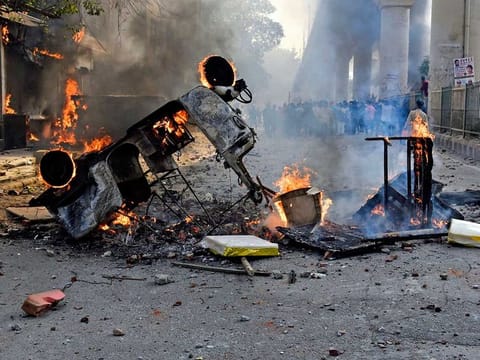 Vehicles set ablaze during clashes between anti-CAA protestors and those supporting the country's new controversial Citizenship law in North-East Delhi on Monday 
