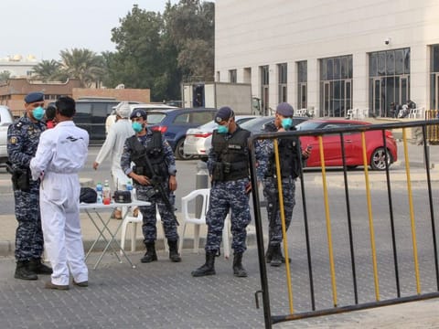 Members of Kuwait's national guard wearing safety masks keep watch outside a hotel in the capital where Kuwaitis returning from Iran are quarantined and tested for coronavirus on February 24.