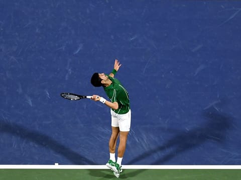 Serbia's Novak Djokovic serves the ball to Tunisia's Malek Jaziri during the Dubai Duty Free Tennis Championships
