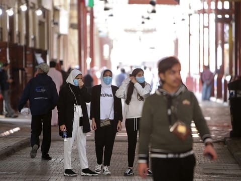 Kuwaiti women wear protective masks at the Mubarakiya Market in Kuwait City