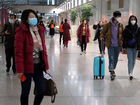 Passengers wearing masks are seen at the terminal hall of the Beijing Capital International Airport, in Beijing, China January 23, 2020. 