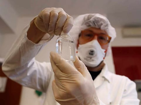 A pharmacist at "Farmacia Bandi" creates a homemade hand sanitiser, as the pharmacy tries to cope with a growing demand from people trying to avoid contracting coronavirus, in Milan, Italy, February 26, 2020. 