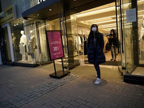 Women wearing masks to prevent contracting the coronavirus walks out of a shop at Dongseong-ro shopping street in central Daegu, South Korea February 21, 2020. 