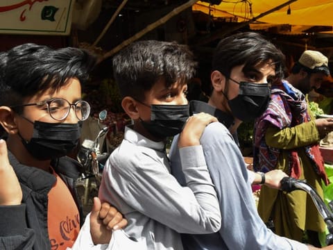 Residents wear protective facemasks as a prevention measure against the COVID-19 coronavirus at a market in Quetta on February 27, 2020 as Pakistan has detected its first two cases of novel coronavirus. Pakistani authorities were scrambling on February 27 to screen hundreds of people who had recently arrived from Iran, which has emerged as a major hotspot for coronavirus, after Islamabad confirmed its first two infections. / AFP / Banaras KHAN