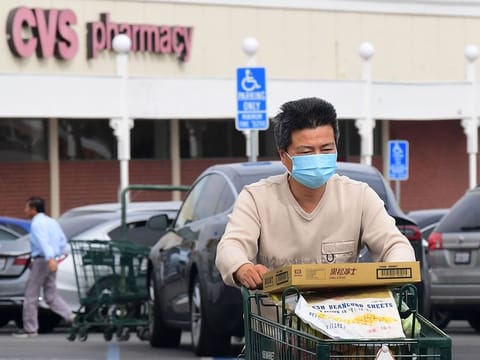 A man wears a facemask while pushing his shopping cart in Alhambra, California on February 27, 2020. 