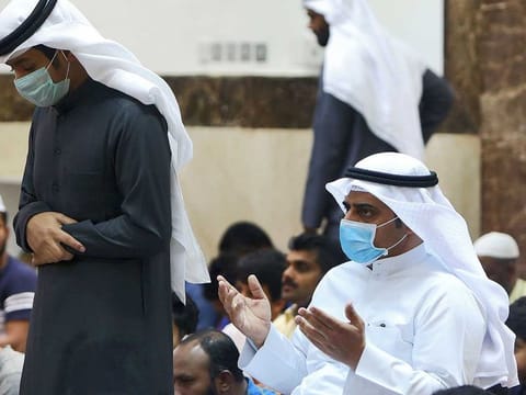 File picture of worshippers wearing protective masks perform prayer at a mosque in Kuwait City on February 28, 2020. 