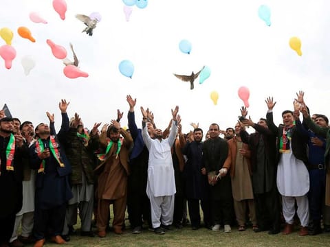 Afghan men celebrate in anticipation of the US-Taliban agreement to allow a US troop reduction and a permanent ceasefire, in Jalalabad, Afghanistan, on February 28, 2020. 