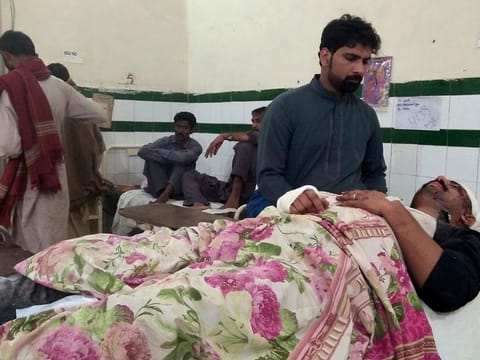 An injured man from train accident is treated at a hospital in Sukkur, Pakistan, Saturday.