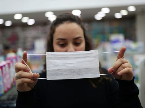 A vendor displays a protective mask at a pharmacy, after the second case of coronavirus in Sao Paulo was confirmed, at Guarulhos International Airport in Guarulhos, Sao Paulo state, Brazil, February 29, 2020. 