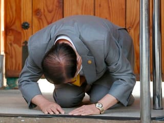 Kneeling, South Korea's sect leader seeks forgiveness for coronavirus spike