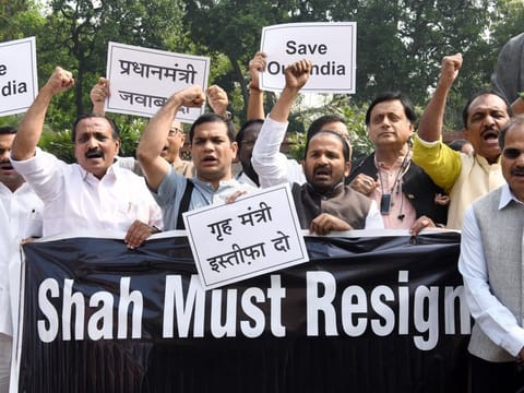 Leader of Congress in Lok Sabha Adhir Ranjan Chowdhury along with party MPs hold placards and shout slogans demanding resignation of Union Home Minister Amit Shah during a protest against the Delhi Riots, during the Budget Session of Parliament in New Delhi on Monday. 