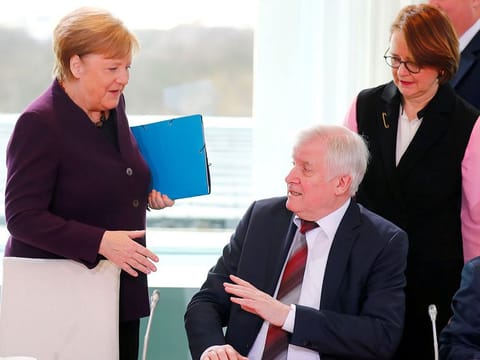 German Interior Minister Horst Seehofer refuses to shake the hand of German Chancellor Angela Merkel for hygienic reasons before a migration summit at the Chancellery in Berli