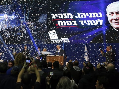 Confetti falls as Benjamin Netanyahu, Israel's prime minister, center right, and his wife Sara Netanyahu stand on stage at the Likud party headquarters in Tel Aviv early on Tuesday.