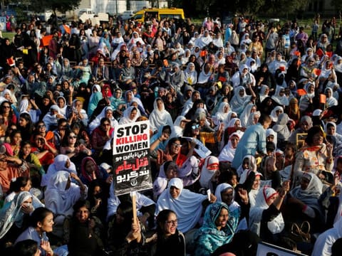 People hold signs and chant slogans as they take part in an Aurat March, or Women’s March in Karachi, Pakistan March 8, 2018. 
