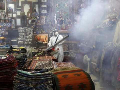 A firefighter disinfects a traditional shopping center to help prevent the spread of the new coronavirus in northern Tehran on March 6.