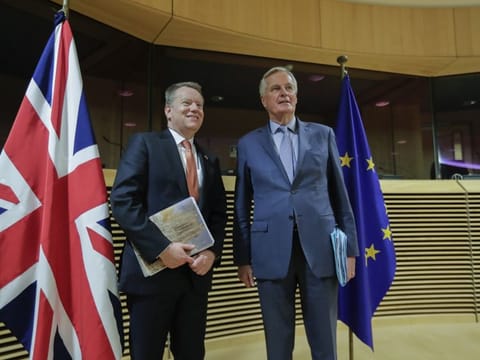 European Union chief Brexit negotiator Michel Barnier, right, speaks with the British Prime Minister's Europe adviser David Frost during the start of the first round of post -Brexit trade talks between the EU and the UK, at EU headquarters in Brussels