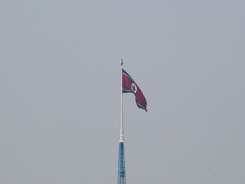 A North Korean flag flutters on top of the 160-metre tall tower at North Korea's propaganda village of Gijungdong.