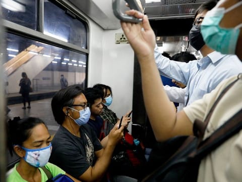 Philippines, Mar 10: Passengers wear protective masks inside a crowded train following new cases of coronavirus in Manila.