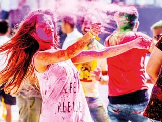 Indian revelers celebrate Holi with huge splash of colours