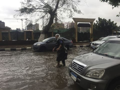 A man wears makeshift rain gear as he navigates a flooded road after heavy rains in the Zamalek district of Cairo, Egypt, Thursday, March 12. Thunderstorms packing heavy rains and lightning caused widespread flooding in Egypt on Thursday, killing several people and causing authorities to shut down schools and an airport, officials said. 