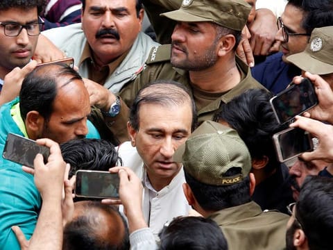 Police officers and media persons gather as Mir Shakilur Rehman, owner and editor-in-chief of Jang media group, publisher of Urdu and English newspapers which runs the popular Geo News TV, leaves after attending court proceedings in Lahore, Pakistan, on March 13, 2020. 