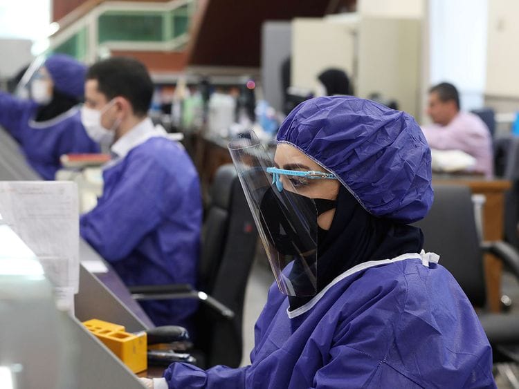 Bank employees wear protective face masks 