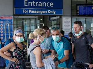 Foreigners prepare to enter the departure area of Manila's International Airport, Philippines