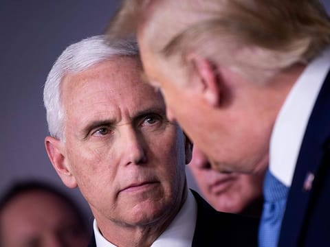 US Vice President Mike Pence and US President Donald Trump talk during a COVID-19 pandemic briefing at the White House in Washington, DC.