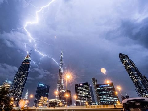 The magnificent Burj Khalifa stands tall amidst the lightning and thunder in Dubai skies