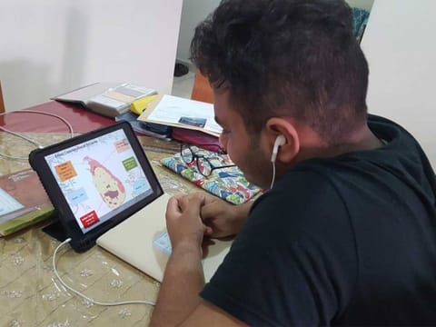 Aaron Abraham, a student of Our Own High School, Al Warqa, attends an e-learning session at home in Dubai on Sunday.
