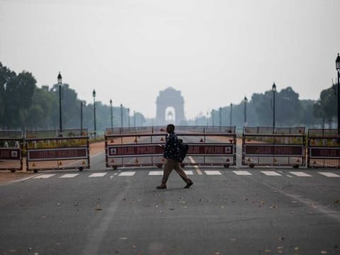 A man crosses Rajpath leading to India Gate in New Delhi. The outbreak of coronavirus has left people across the socio-economic strata worried in equal measure. 