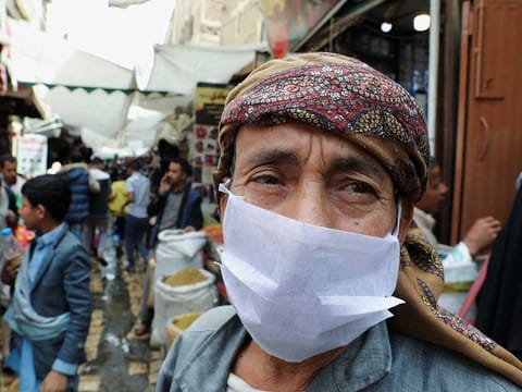 A man wears a protective face mask amid fears of the spread of the coronavirus disease (COVID-19), at a market in the old quarter Sanaa, Yemen, on March 18, 2020. 