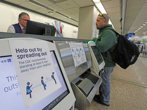 A sign is shown at the United ticketing counter at the Salt Lake City International Airport Wednesday, March 25, 2020, in Salt Lake City. Many airline flights are nearly empty as virus undercuts travel. 