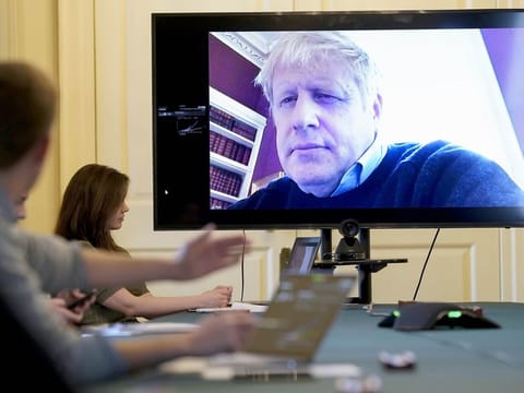 In this handout photo provided by Number 10 Downing Street, Britain's Prime Minister Boris Johnson chairs the morning Covid-19 Meeting remotely after self isolating after testing positive for the coronavirus, at 10 Downing Street, London, Saturday, March 28, 2020. The new coronavirus causes mild or moderate symptoms for most people, but for some, especially older adults and people with existing health problems, it can cause more severe illness or death. 