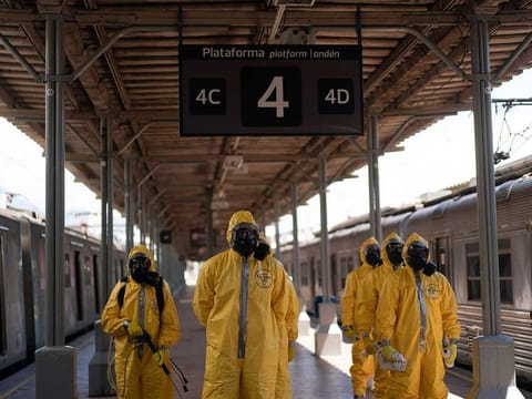 Soldiers stand in formation before disinfecting wagons for the new coronavirus at the central train station in Rio de Janeiro, Brazil, where trains connect cities within the state, on Thursday, March 26, 2020.